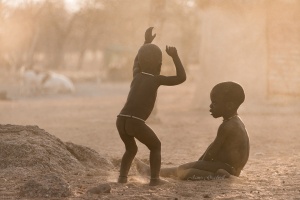 Himba Boys playing in dust, Kamanjab. Namibia Photo Tours